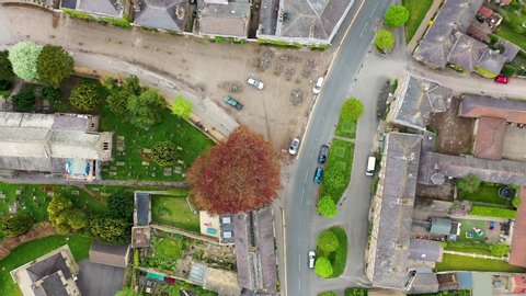 Top down aerial footage of the small village of Ripley in Harrogate, North Yorkshire in the UK showing the historical British UK old stones cottages in the small village.