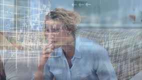 Animation of stock market display over a woman sitting on a couch, watching a scary movie, eating popcorn. Finance business stock market global data processing concept digitally generated image. - Powered by Shutterstock - Get 15% off with code: PIKWIZARD15