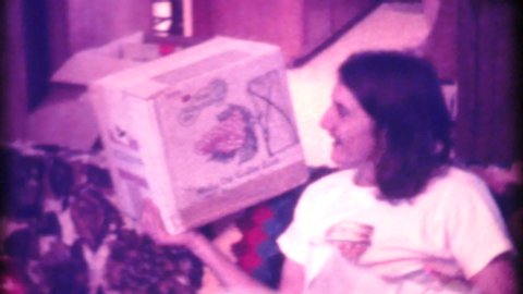 TRENTON, NEW JERSEY, DECEMBER, 1974: A beautiful family enjoys opening presents and spending time together on Christmas morning in 1974.