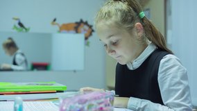 This stock video features a girl completing her homework as she works in her bedroom on quarantine.

