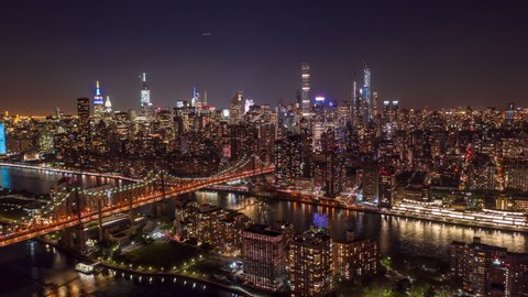 New York City / USA - September 20, 2019 : New York City above East river showing Manhattan by night aerial hyperlapse