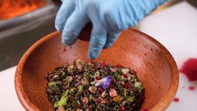 A cook knocks grains from pomegranate into a salad. The cook takes out grains from pomegranate for salad with quinoa     - Powered by Shutterstock - Get 15% off with code: PIKWIZARD15