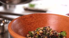 Close shot cook puts quinoa salad on a plate     - Powered by Shutterstock - Get 15% off with code: PIKWIZARD15