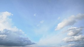 Video timelapse of beautiful clear sunny blue sky and peaceful fluffy white clouds flying overhead.