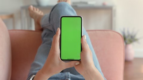 Phone with Green Screen and Chroma Key. Chromakey Mockup with Tracking Markers and Alpha Matte. Concept of Relaxing Online Shopping on Sofa Close Up. Hipster Chatting or Surfing on Web Blog with News