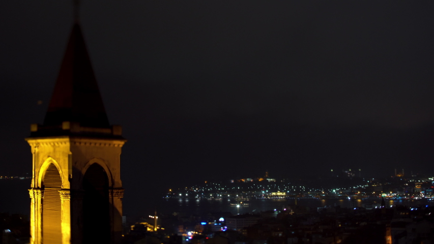 Night panoramic view on bell tower and central and historical part of Istanbul, the gulf Golden Horn. On the gulf on night fires the ship floats.