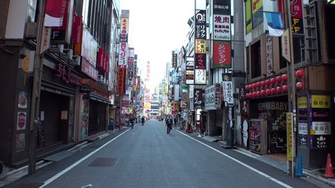 TOKYO, JAPAN - 28 APRIL 2020 : View around Shinjuku Kabukicho area. Tokyo governor called refrain from going outside, due to concerns over Coronavirus. Street is normally busy, but lightly populated.