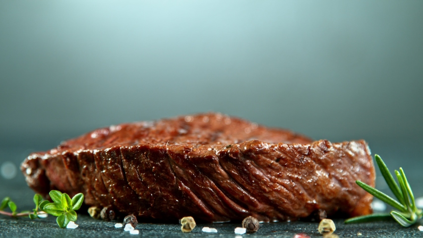 Close-up of falling tasty beef steak, super slow motion, filmed on high speed cinematic camera at 1000 fps. Royalty-Free Stock Footage #1051687072