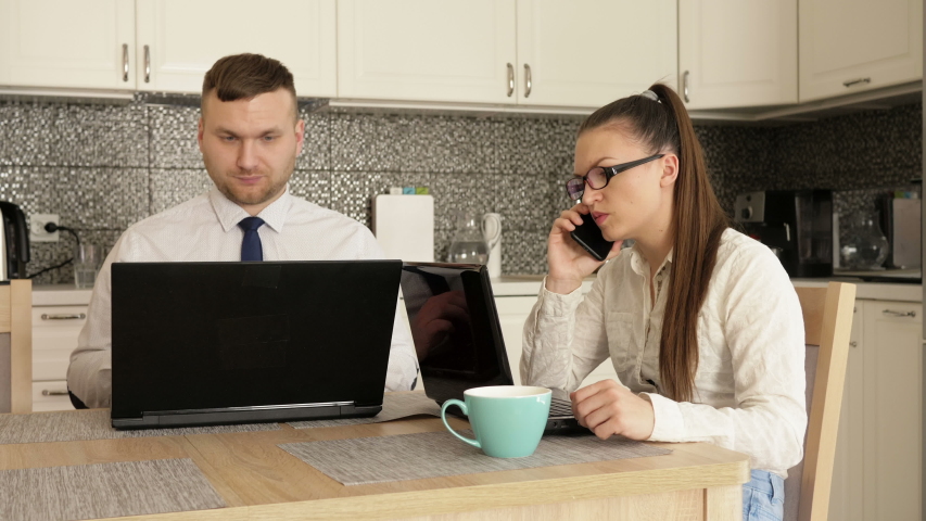 Online business.Young married couple working at home.