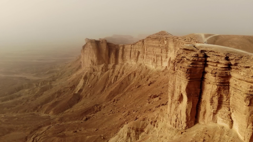Aerial of The Edge of the World (Jebel Fihrayn) is an unexpected and dramatic geological wonder in the rocky desert northwest of Riyadh, Saudi Arabia | Shutterstock HD Video #1051698583