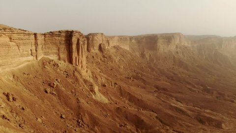 Aerial of The Edge of the World (Jebel Fihrayn) is an unexpected and dramatic geological wonder in the rocky desert northwest of Riyadh, Saudi Arabia