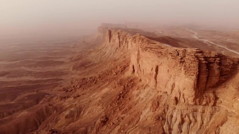 Aerial of The Edge of the World (Jebel Fihrayn) is an unexpected and dramatic geological wonder in the rocky desert northwest of Riyadh, Saudi Arabia