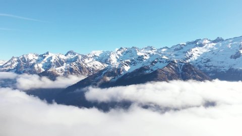 DRONE FOOTAGE - Snow and mountain peaks in the french Pyrenees near the Luchon Superbagnères Ski Resort in Saint-Aventin, France. The Luchonnais Mountains aerial view.