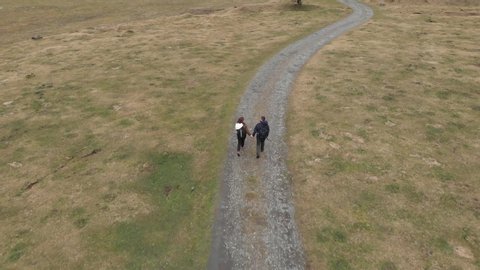 DRONE FOOTAGE - The Val d’Astau, southwest of Bagneres de Luchon in the French Pyrenees. Romantic couple holding hands walking in mountain.