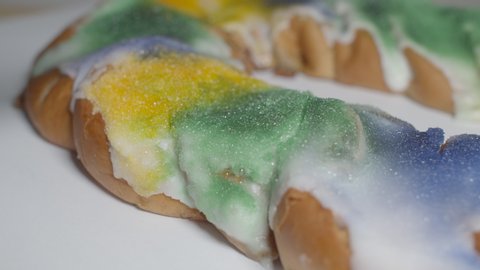 Classic New Orleans King Cake Close Up Spinning on a White Background