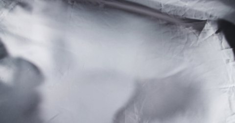 Grey and White silk satin sheet flag flowing in wind / slow motion / background texture