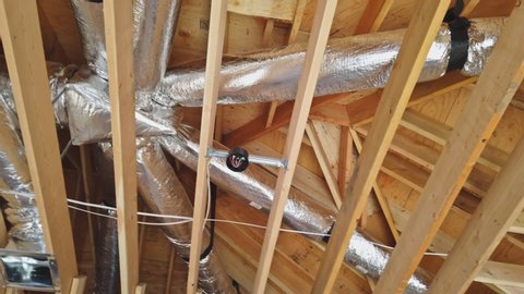 Ceiling mounted hvac system under insulated air conditioner return in new home construction
