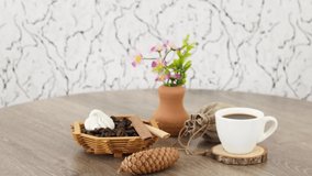 Coffee cup with candies on wooden table background.