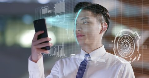 businessman use facial recognition system by smartphone at night in the office