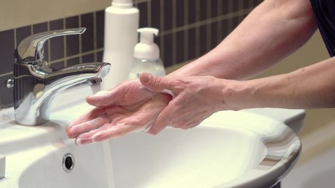 Good hand hygiene technique. Protect yourself from germs and the Covid19 coronavirus. Careful and prolonged soaping and washing off of hands.