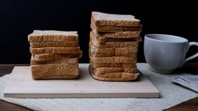 4k stop motion bread with coffee cup on black background.