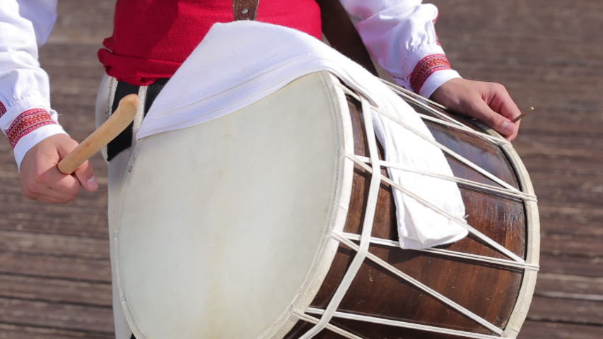 Man Playing on Traditional Folk Drum in Folklore Costume