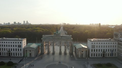 AERIAL: Over Brandenburger Tor with almost no People in Berlin, Germany due to Corona Virus COVID19 Pandemic in Beautiful Sunset Light