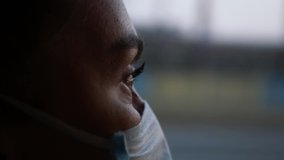 A young Woman in a protective mask rides public transport and looks out the window. Portrait of a woman in a protective mask on a social bus. Pandemic COVID-19. Social distance. - Powered by Shutterstock - Get 15% off with code: PIKWIZARD15