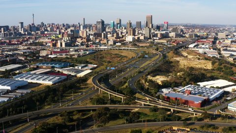 AFRICA,SOUTH AFRICA,CIRCA 2020. Scenic aerial view of Johannesburg highway traffic almost non-existent due to Coronavirus Covid-19 Pandemic.  Johannesburg skyline in the background.
