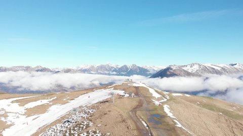 DRONE FOOTAGE - Snow and mountain peaks in the french Pyrenees near the Luchon Superbagnères Ski Resort in Saint-Aventin, France. The Luchonnais Mountains aerial view.