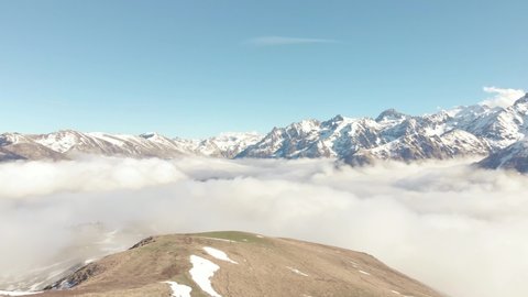 DRONE FOOTAGE PAN - Snow and mountain peaks in the french Pyrenees near the Luchon Superbagnères Ski Resort in Saint-Aventin, France. The Luchonnais Mountains aerial view.