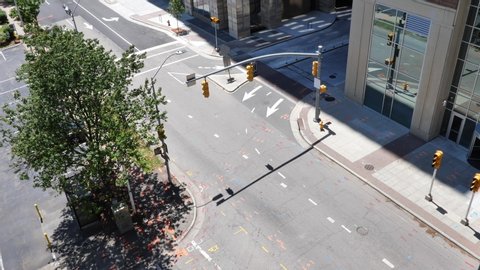 Raleigh, NC / USA - May 2 2020: Looking down at an empty downtown intersection then panning up to show the quiet streets during COVID-19 pandemic lockdown