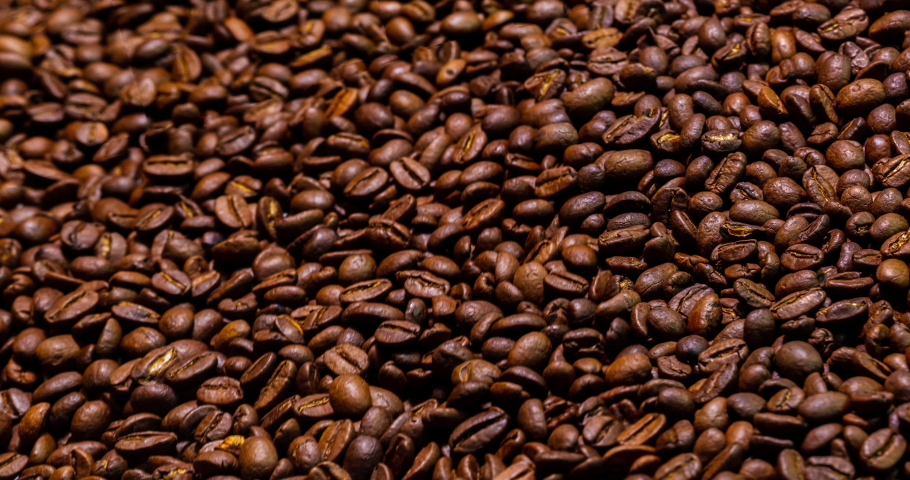 Fresh roasted coffee beans. 4k detailed macro capture of thousands of brown fresh roasted coffee beans. Aromatic smelling roast. Close up to coffee beans