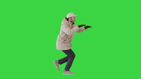 Hip-hop man singing rap, walking and making gestures on a Green Screen, Chroma Key.