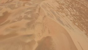 Sand storm on top of a sand dune. Windy weather conditions. Aerial video.