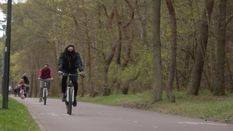 Berlin, Germany. 05. April. 2020. 
Masked people ride bicycles and masks in the park to quarantine the corono virus. Allowed to walk in the parks on the beaches and keep their distance during.