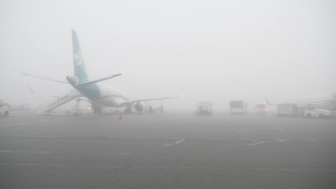 Munich airport, Germany - May 2020 - Airplane preparing for flight in fog