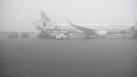 Munich airport, Germany - May 2020 - Lufthansa plane preparing for first flight in fog after quarantine