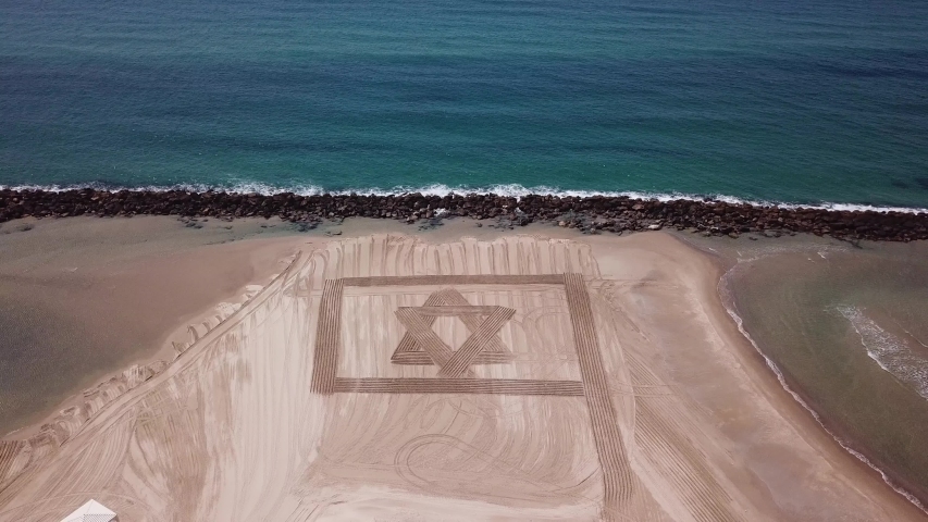 ISRAEL Flag in Sand on a beach. Aerial view.