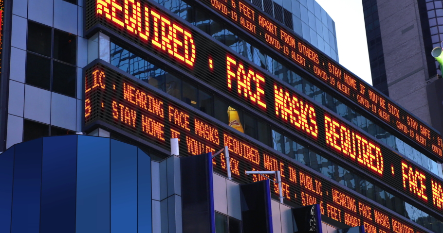 A fictional Times Square stock market ticker reminds pedestrians to wear face masks during the COVID-19 pandemic of 2020. Custom messages available upon request.  	 Royalty-Free Stock Footage #1051816495