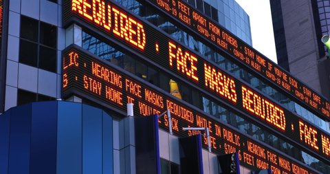 A fictional Times Square stock market ticker reminds pedestrians to wear face masks during the COVID-19 pandemic of 2020. Custom messages available upon request.  	