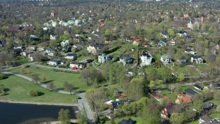 Aerial drone shot of Djursholm Stockholm suburban in Danderyd Municipality, wealthiest community in Sweden. Aerial of luxury estate, fancy mansions, big houses with huge garden properties Royalty-Free Stock Footage #1051817101