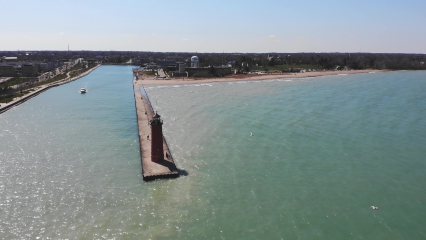 A red lighthouse standing on the shores of Lake Michigan. Lighthouse by the lake in Kenosha, Wisconsin, USA