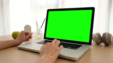 Female hands on touchpad on laptop with green screen. Office person using laptop computer with laptop green screen