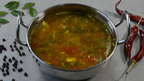 Spicy rasam is a popular south indian soup eaten by mixing with white rice.