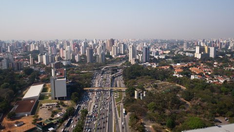  4K UHD Hyperlapse aerial drone footage of motorway 23 de maio in Sao Paulo, Brazil High view looking down on busy traffic at junction in sunny day. Long exposure city life and transportation.