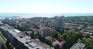 Sochi city on the background of the sea. Quadcopter flight over the city center. View of the Riviera Park and the streets: Yegorova, Konstitutsii, Vorovskogo, Ostrovskogo.