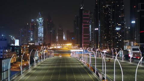 Dubai, United Arab Emirates - 04/30/2020 : Sliding beauty shot of empty roads of the city of gold Dubai in lockdown due to corona, drone shot.