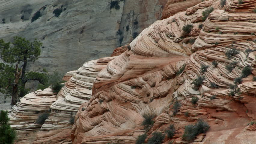 MESMERIZING WEATHERED ROCK FORMATIONS.  LAYERS UPON LAYERS OF RED SANDSTONE REVEAL WHAT TIME & MOTHER NATURE CAN DO TO A MOUNTAIN.  SHOT IN ZION NATIONAL PARK, UTAH.