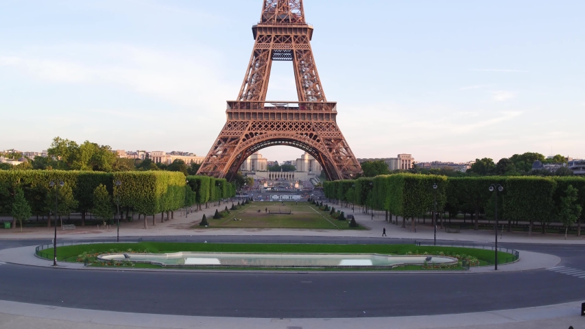 France, Paris, Tour Eiffel (Eiffel tower) champ de mars with La Defense and Trocadero background, at sunrise . 4k High Quality shot, aerial drone view. Royalty-Free Stock Footage #1051872307